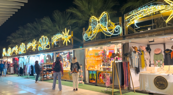 Christmas Market at Muelle Uno, Málaga Illuminated stalls at the Christmas Market in Muelle Uno, Málaga, offering crafts and decorations