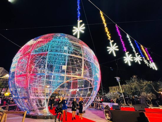 Illuminated Christmas Sphere in Fuengirola Large illuminated Christmas sphere in Fuengirola with people gathered around during a performance